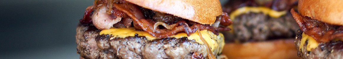 Eating Burger at Loop 107 Burgers, Bakery and More restaurant in Adkins, TX.